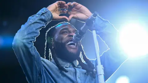 Getty Images Burna Boy making a heart sign