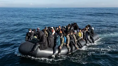 Getty Images A dinghy carrying around 65 migrants crosses the English Channel