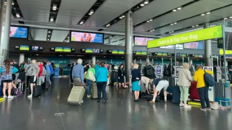 RTE Dozens of passengers at the bag drop area of Dublin Airport's Terminal 2