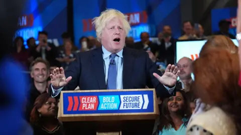 PA Media Boris Johnson appears at a Tory campaign rally
