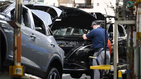 Getty Images An employee works on a Nissan Qashqai car on the production line at the Nissan factory in Sunderland