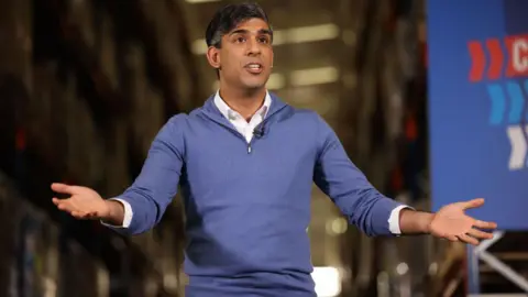 Getty Images Rishi Sunak holds his hands open while campaigning in the general election