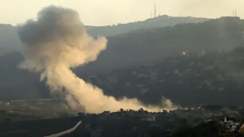 EPA Smoke rises following an Israeli strike in Kafr Kila, southern Lebanon (2 October 2024)