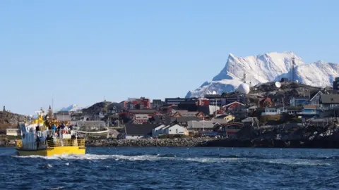 A yellow boat just off the coast of Greenland's capital Nuuk.