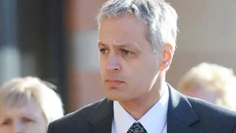 PA Media Robin Garbutt wearing a grey suit, arriving at Teeside Crown Court, Middlesbrough for the start of his trial in 2011, where he convicted of murdering his postmistress wife, Diana