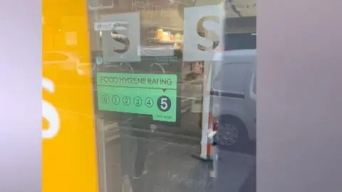 A shot of the hygiene rating certificate of five at Sainsbury's Local store at 297 High Road in Leyton, east London