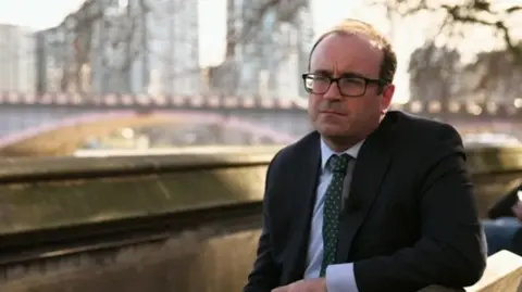 BBC Aaron Bell sitting by the River Thames