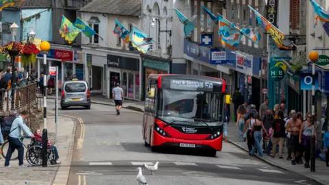 Getty Images A bus driving through a Cornwall town 