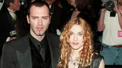 Getty Images The pair attended many events together, including this Vanity Fair Oscars party in 1998. Ciccone is wearing a black tux and Madonna is in a black and grey sleeveless dress with a plunging neckline