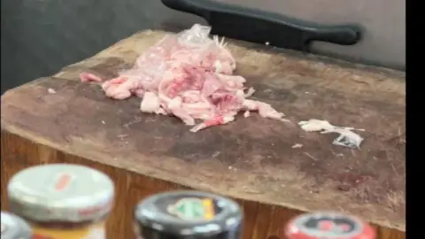 Uncooked meat on a wooden board at Nadeem Halal Meat & Grocery