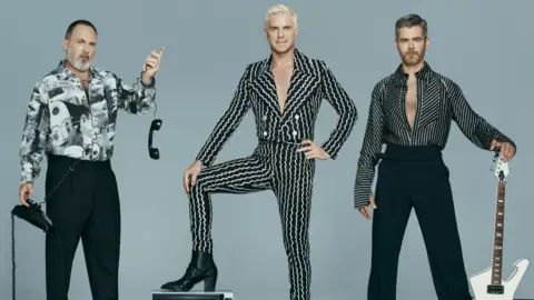 Fascination The Scissor Sisters pictured with a guitar, telephone and television set. Left to right: Babydaddy, Jake Shears and Del Marquis