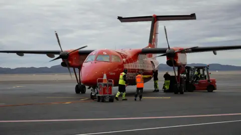 BBC A small plane at Nuuk Airport in Greenland.