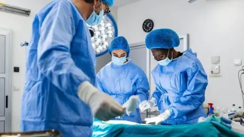 Getty Images Doctors in operating theatre