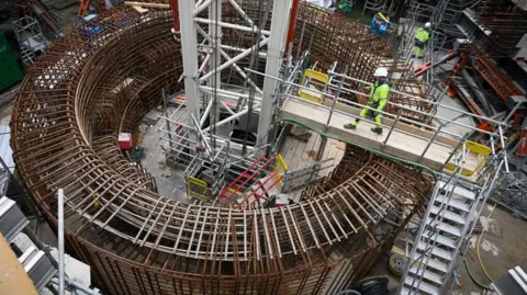 Getty Images A workman at Hinkley Point C nuclear power station, which is being constructed in the southwest of England