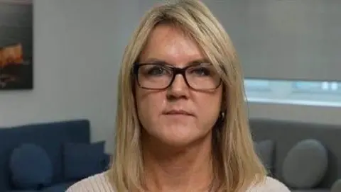 Janet Skinner, wearing glasses, was wrongly sent to prison for faults made by Horizon software