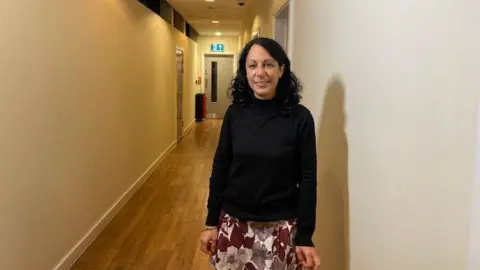 St Mungo's CEO Emma Haddad standing in a corridor