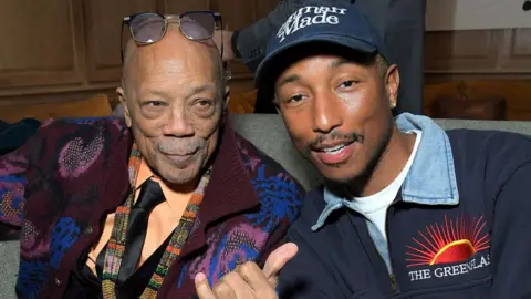 Getty Images Quincy Jones and Pharrell Williams sitting together in 2020