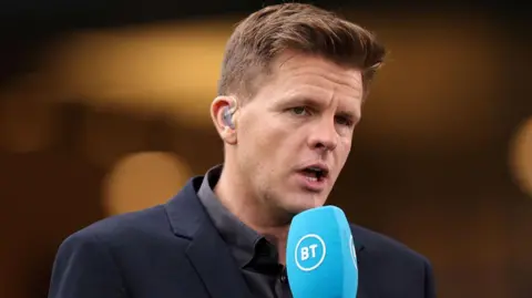 Getty Images Jake Humphrey when he worked at BT Sport (now TNT Sport). He is wearing a navy jacket and grey shirt and has short light brown hair with a quiff