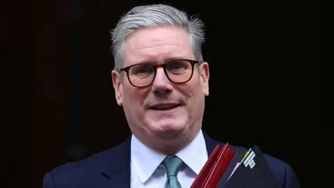 Reuters Prime Minister Sir Keir Starmer leaving Downing Street holding red and black folders