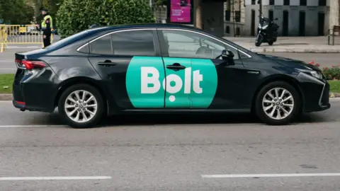 Getty Images A black car with a green Bolt logo