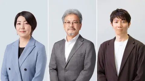 Nintendo A three-part composite image shows three people in smart clothing posed against a plain background in a professional headshot style. On the left a woman with neat, short black hair wears a pale blue suit jacket over a black top. In the centre a man with glasses, grey hair and a beard wears a grey suit as he smiles gently. On the right a younger man with mid-length black hair wears a brown blazer over a white t-shirt. 