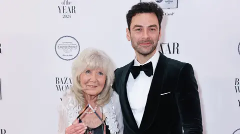 Getty Images Dame Jilly Cooper and Aidan Turner smiling 