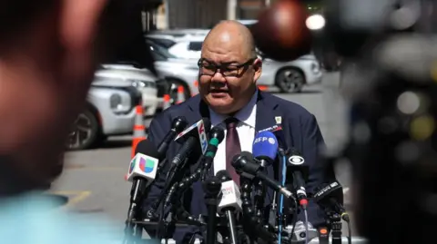 Getty Images File image of Steven Cheung speaking into microphones at a press conference 