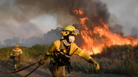 Getty Images Firefighters battle flames 