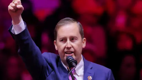 Reuters File image of Sergio Gor with his fist raised at a Trump rally