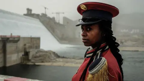 Getty Images A member of Ethiopia's Republican March Band poses for photo before at the ceremony for the inaugural production of energy at the Grand Ethiopian Renaissance Dam in Guba, Ethiopia, on 20 February 2022