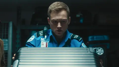 Netflix Taron Egerton as TSA agent Ethan Kopek in new film, Carry-On.