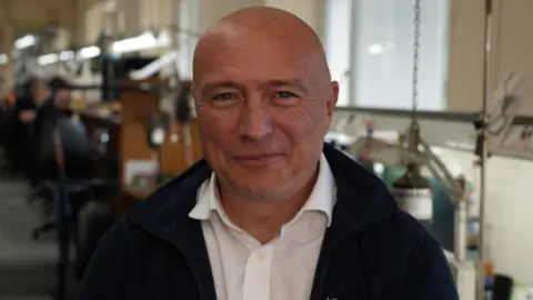 Gary Wroe Gary Wroe who is the Managing Director of Hockley Mint smiles in a white shirt in an office