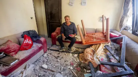 Reuters Moussa Zahran sits inside his damaged apartment in Barja, Lebanon (6 November 2024)