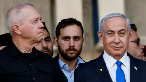 Reuters Yoav Gallant (L) stands beside Benjamin Netanyahu (R) during a ceremony an Israeli military base near Mitzpe Ramon, Israel (31 October 2024)