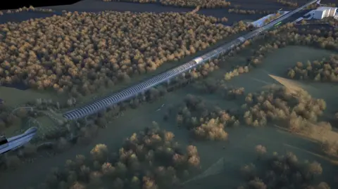 PA Ariel view of an artist's impression of Sheephouse Woods with the railway running alongside it, covered by the curved barrier to protect bats - which looks like a tunnel that is above ground.