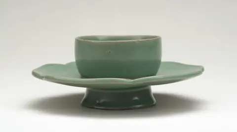 PA Media A green bowl stand which looks like a cup and saucer joined together