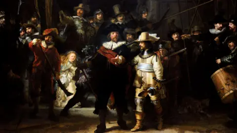 Getty Images The Night Watch shows a captain and lieutenant surrounded by their company