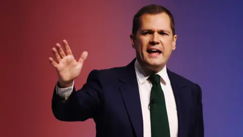 Getty Images Robert Jenrick delivers his speech on the final day of the Conservative conference in Birmingham