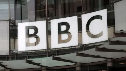 EPA File image showing the BBC logo above the entrance to New Broadcasting House, consisting of a white silhouetted logo on curved glass