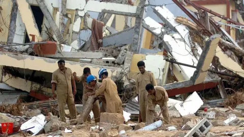 Getty Images MALACCA, INDIA: Indian airforce personnel attempt to uncover documents from a time record room in Malacca on Car Nicobar Island, 07 January 2005,which was totally destroyed by the tsunamis of 26 December 2004. Almost 1,200 people are listed as killed, with 5,600 missing on the Andamans archipelago. Some 44,000 survivors are housed in shelters on the Indian Ocean tropical chain of over 500 islands strung across 800 kilometres (500 miles) and located just east of Sumatra.