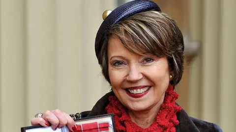 Getty Images Lady Catherine Meyer holds her Commander of the British Empire(CBE) during a ceremony at Buckingham Palace in 2013.