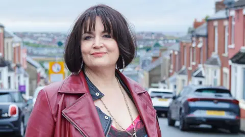 BBC/Toffee International Ltd./Tom Jackson Gavin & Stacey star Ruth Jones as her iconic character, Nessa, during filming of the hit BBC sitcom on Trinity Street, Barry.