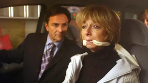 ITV Gail looking frightened in a car while being kidnkapped along with her family by her third husband Richard Hillman