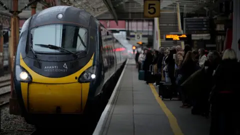 Getty Images Avanti West Coast train with passengers waiting on a platform