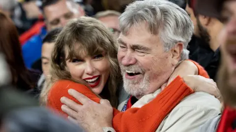 Getty Images Taylor Swift hugs Ed Kielce after the AFC Championship NFL football game between the Kansas City Chiefs and Baltimore Ravens at M&T Bank Stadium on January 28, 2024 in Baltimore, Maryland