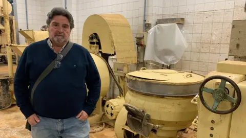 Guy Hedgecoe Businessman Pascual Andreu stands in his factory, which was damaged by flood water