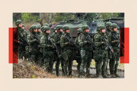 Getty Images Army soldiers holding guns take part in an exercise in Taitung 