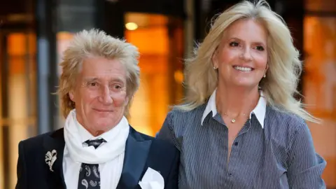 Max Mumby/Indigo / Contributor/Getty Images Penny Lancaster pictured with her husband, Sir Rod Stewart. Both are smiling as they attend the WellChild Awards 2024 at the Royal Lancaster Hotel 