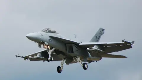 BBC A US Navy Boeing F/A-18 Hornet fighter jet coming in to land