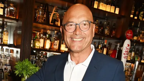 Getty Images Gregg Wallace standing at a bar and smiling